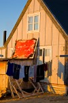 Muskox pelt and laundry hanging to dry outside an Inuit house